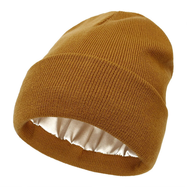 Mustard-brown ribbed knit beanie with turned-up cuff, showing the smooth satin lining inside 1