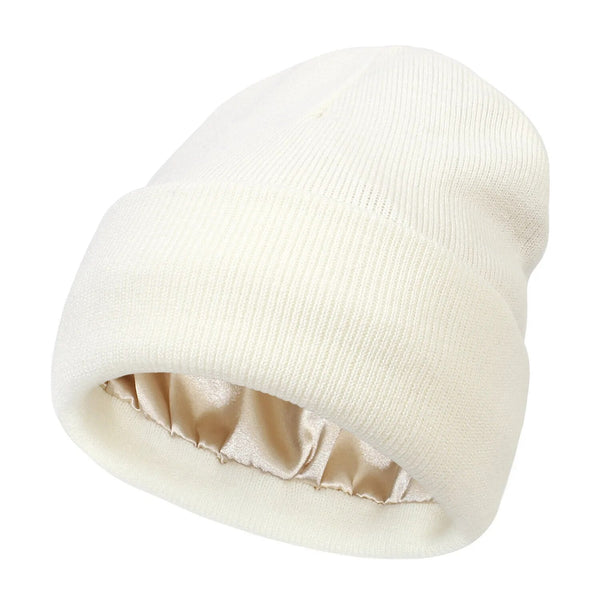 Off-white ribbed knit beanie with folded cuff and champagne satin lining visible inside 5
