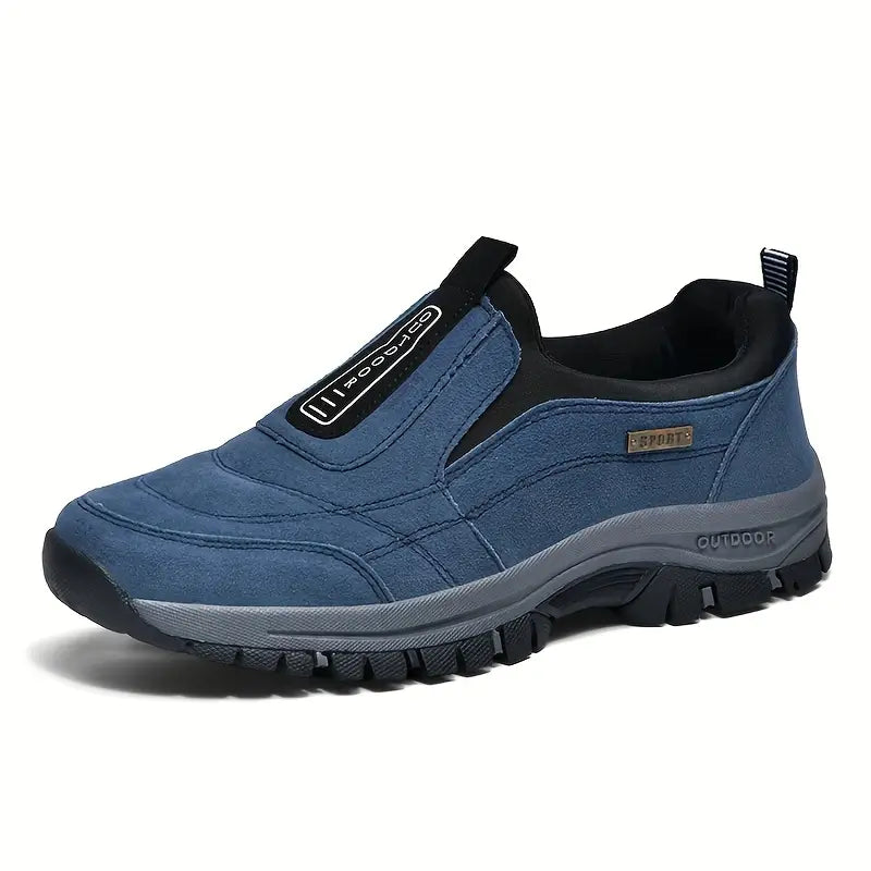 Blue suede-look slip-on shoe seen from the front three-quarter angle, with black elastic side panel and chunky grey and black tread sole. 2