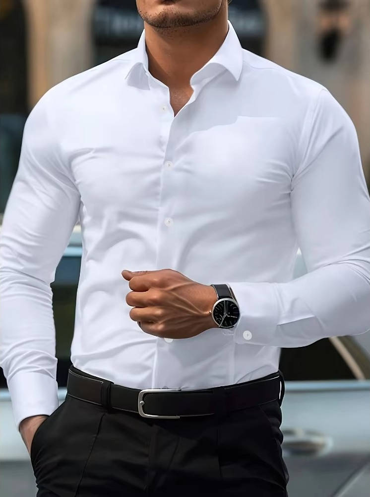 Model wearing the shirt in white with black trousers and belt, one hand clenched near the waist 9