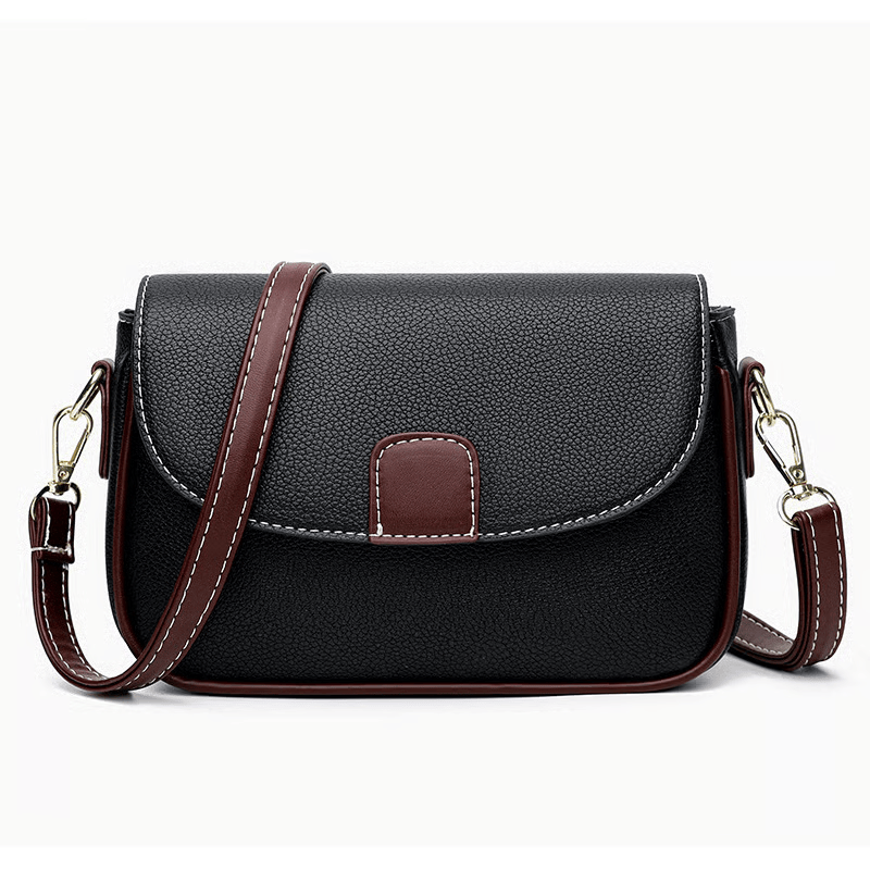 Black crossbody bag with brown strap and white contrast stitching, shown front-on against white 5