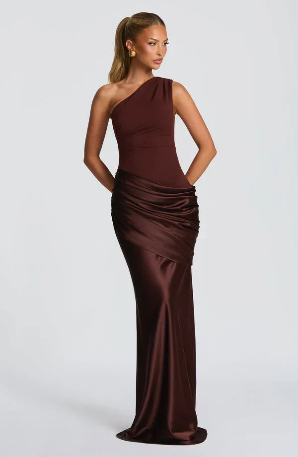 Chocolate brown dress on a model with hands behind her back, looking away from the camera. 10
