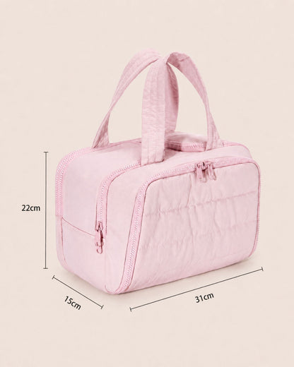 Pink quilted bag at a three-quarter angle with measurement lines marking its height, width and depth. 4