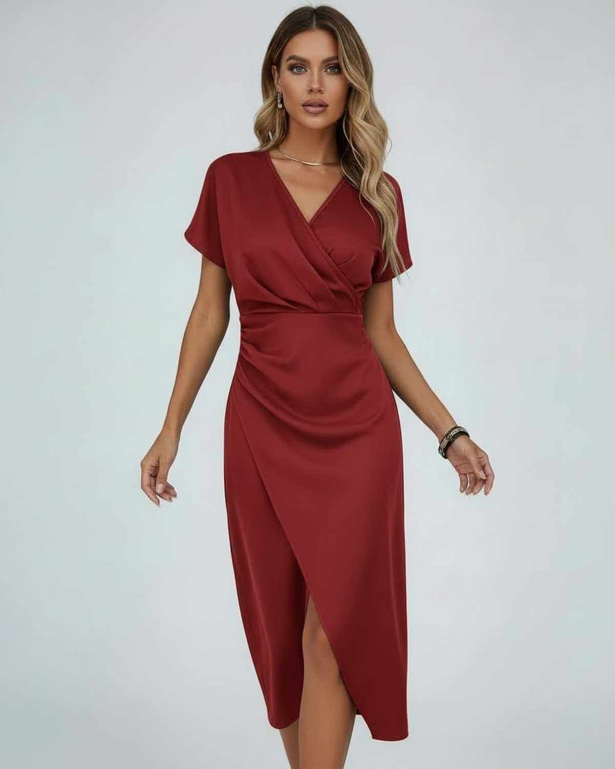 Model wearing the short-sleeved wrap dress in brick red, arms relaxed at her sides 4