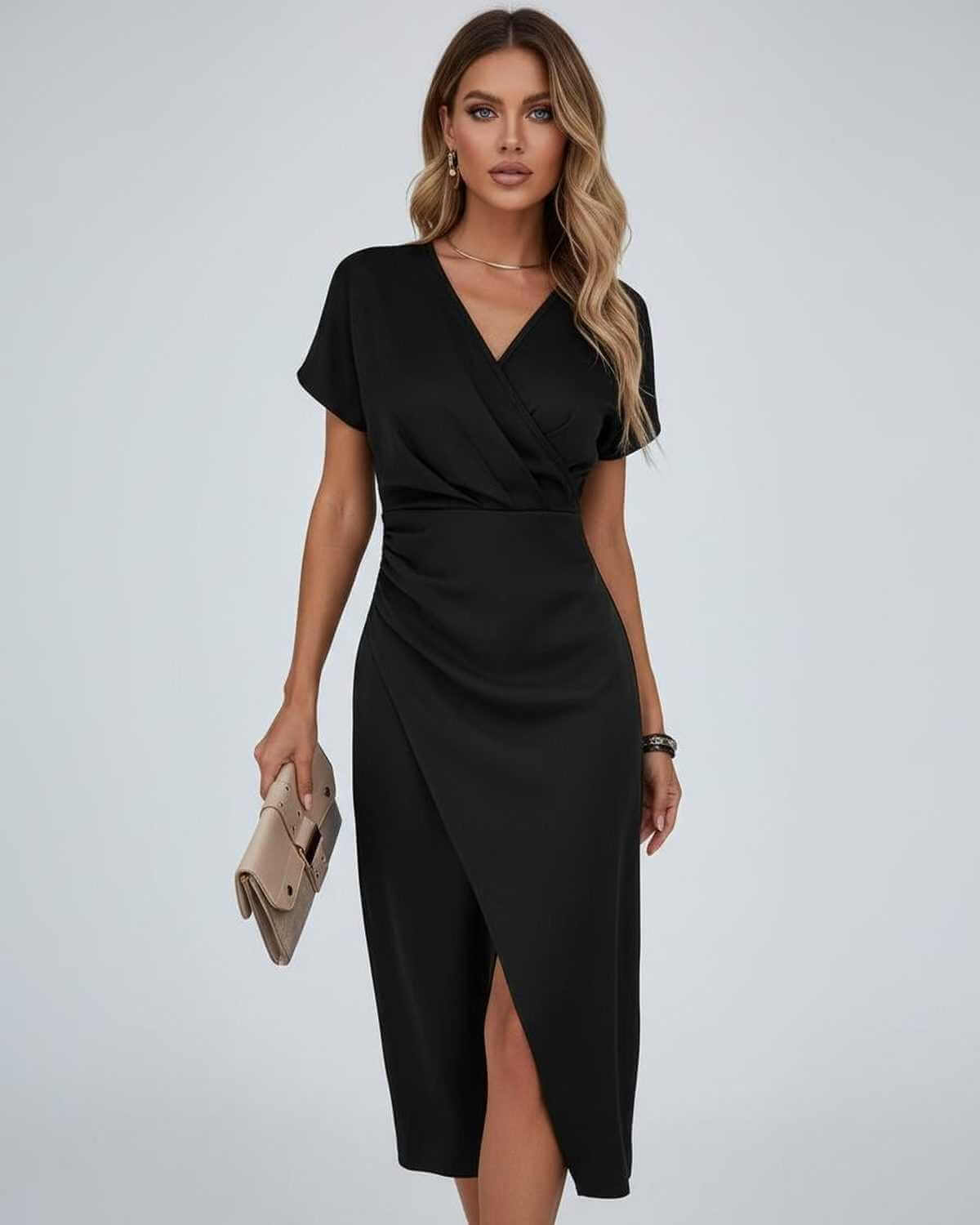 Model wearing the short-sleeved wrap dress in black, holding a beige clutch bag 5