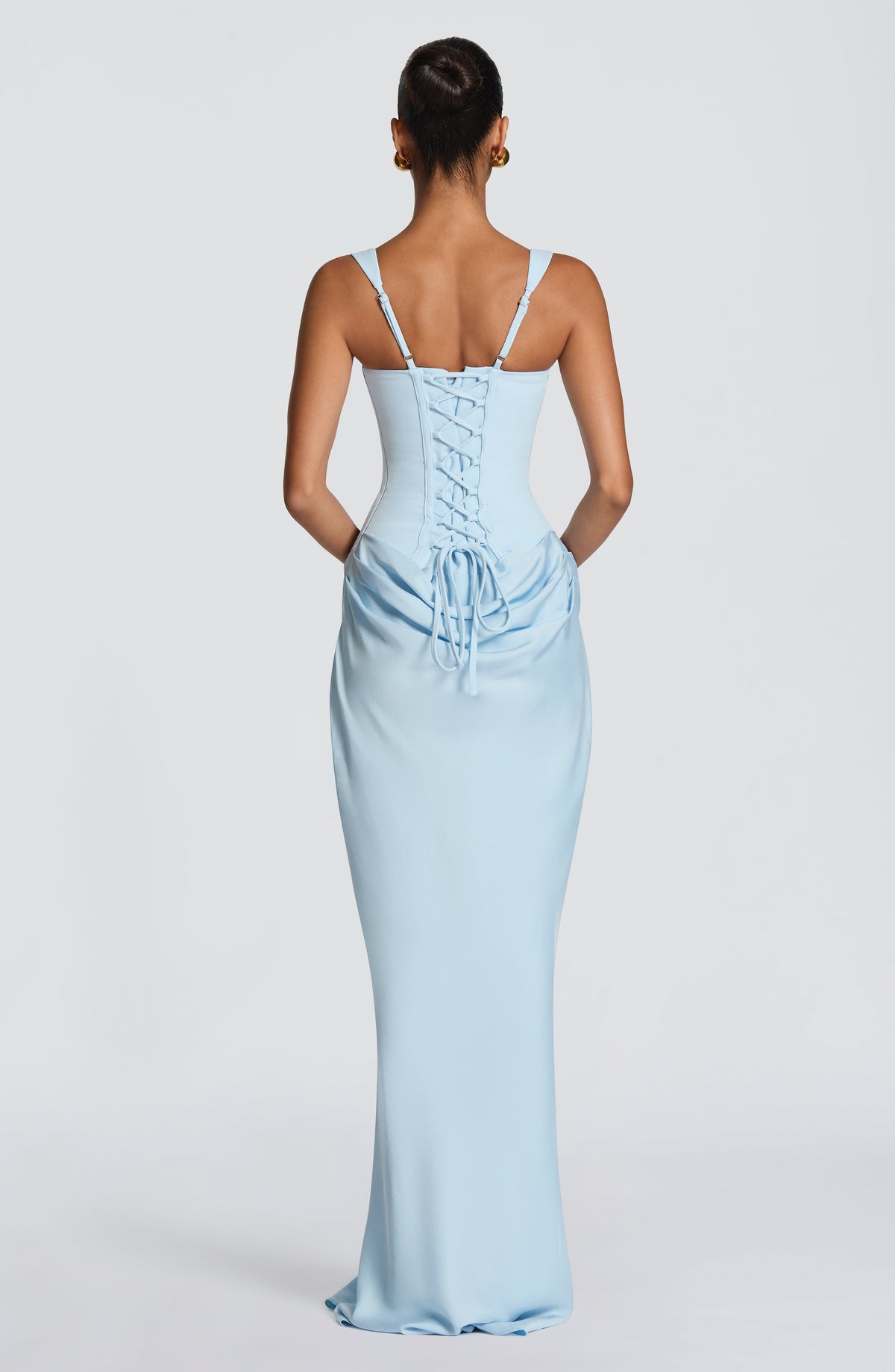 Back view of the light blue maxi dress, showing the corset lace-up closure, adjustable straps and draped gathers below the waist. 28