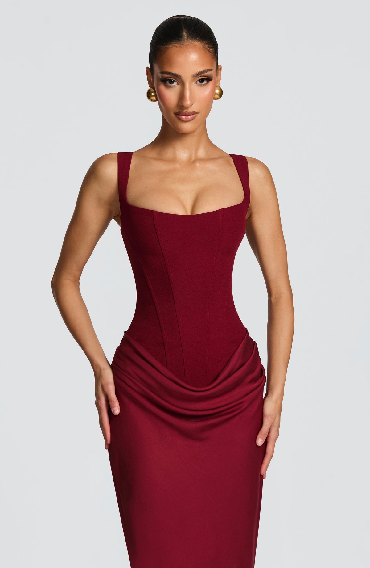 Upper-body close-up of the burgundy dress, showing the wide straps, scooped square neckline and fitted corset bodice. 26