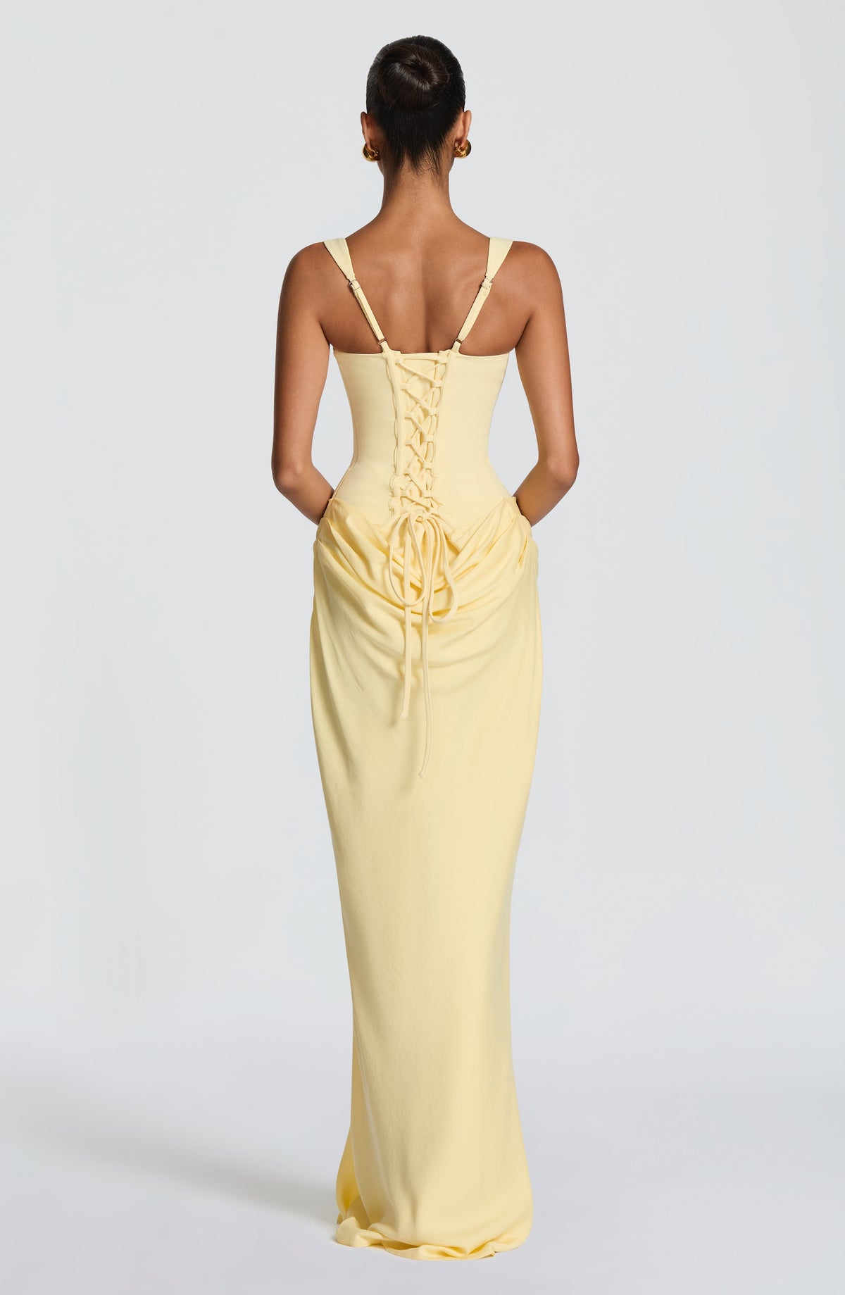 Back view of the pale yellow dress, showing the criss-cross lace-up corset back and gathered drape below 11