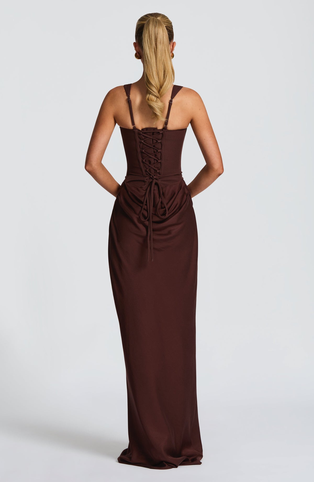 Back view of the brown dress showing the lace-up corset back, adjustable straps and gathered drape over the hips. 2