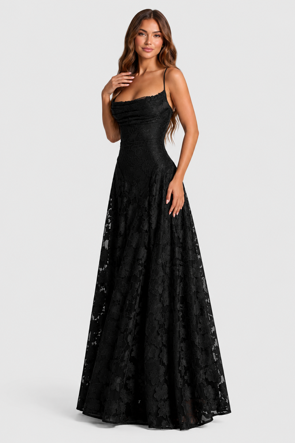Black lace gown on a model with one hand at her collarbone, showing the cowl neckline and flared skirt. 11