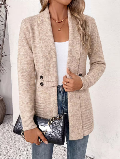 Woman in the beige cardigan holding a black crocodile-effect chain bag, shown from the front 3