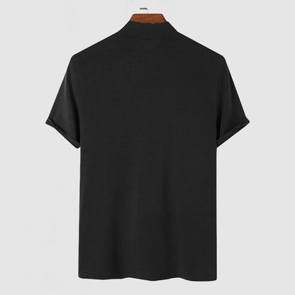 Back view of the black mock-neck tee on a wooden hanger, showing plain fabric and the high neckline. 6