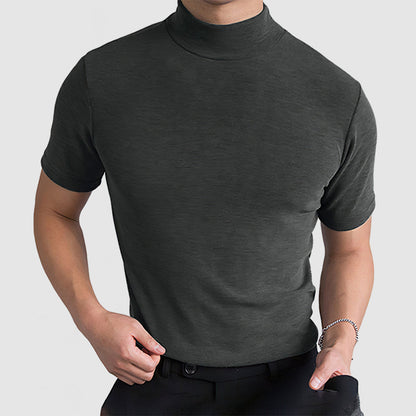 Dark grey mock-neck tee on a model with one hand at the belt and a bracelet on the wrist. 9