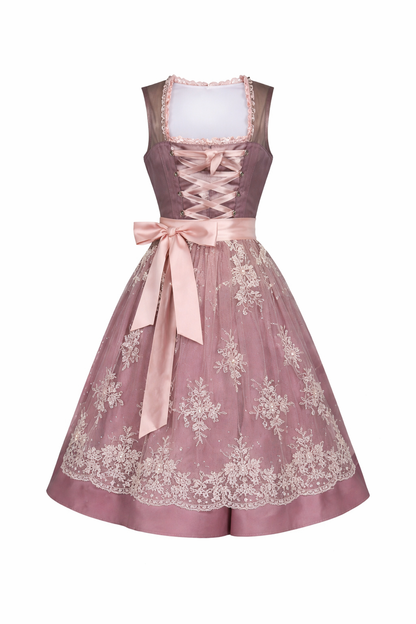 Front view of a mauve dirndl with pink lace-up ribbon, pink satin bow and a cream floral lace overlay skirt. 3