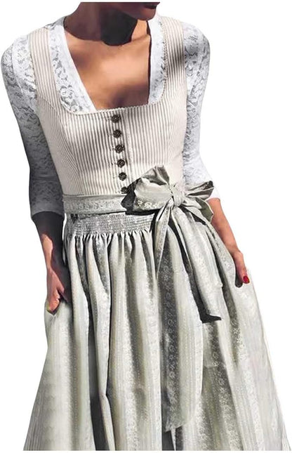 Close-up of the worn dirndl showing the square neckline, button placket, lace sleeves and smocked apron waistband tied in a bow. 3