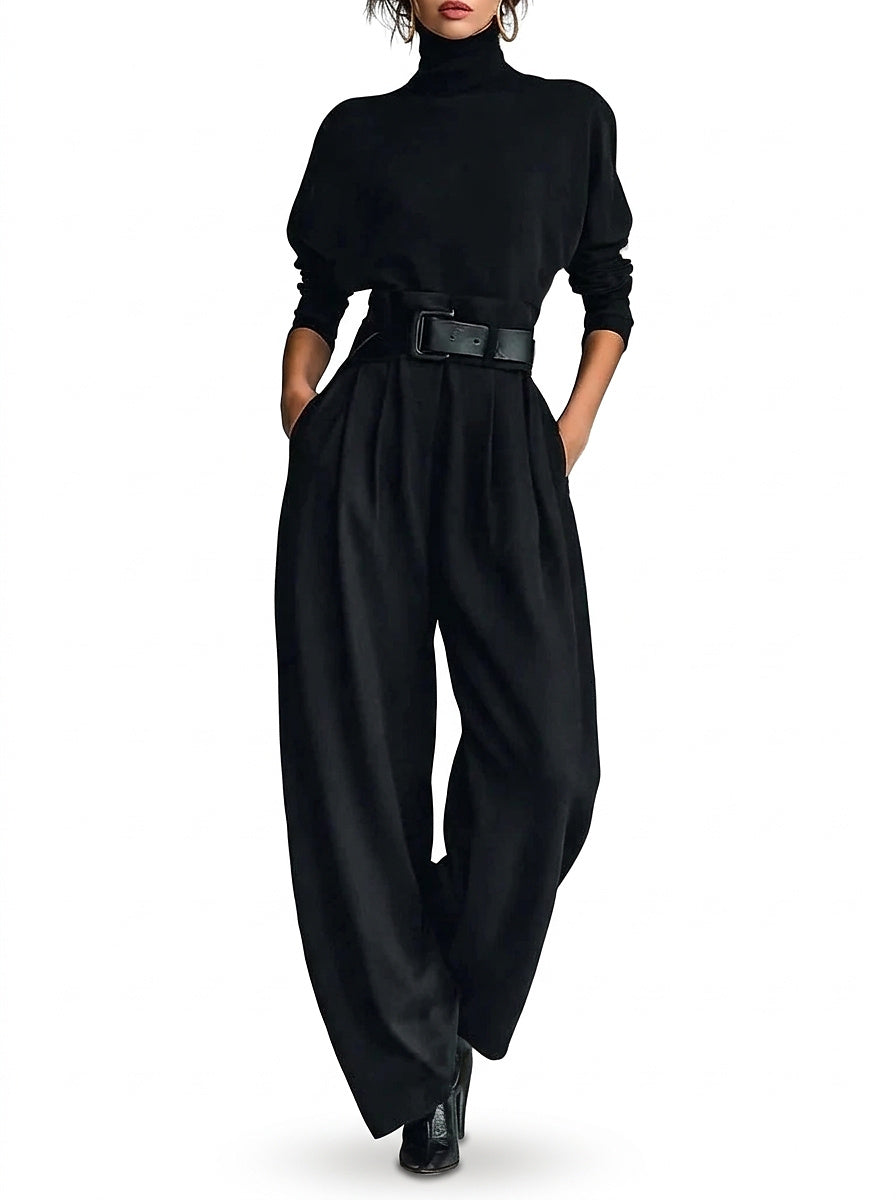 Model in the black set with a wide leather belt, hands in pockets, full-length front view 1