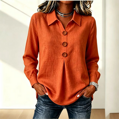 Orange version of the shirt worn with jeans, collar open at the neck 12