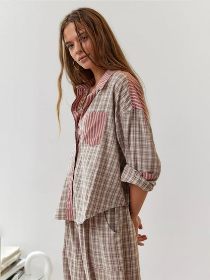 Model in the pink-and-beige check pyjama set with striped collar and pocket, shown from the side with sleeves pushed up. 2