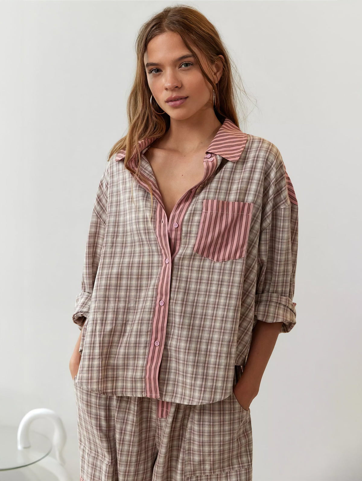 Front view of the pink check pyjama shirt with striped placket and chest pocket, worn open at the collar with sleeves rolled. 4