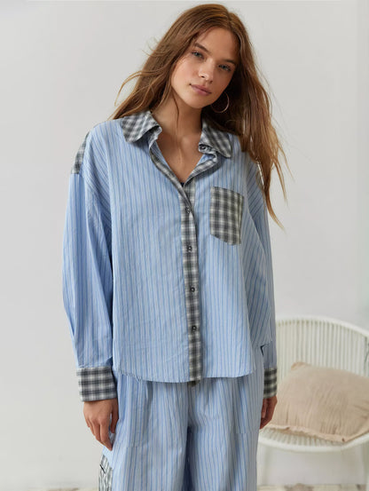 Front view of the blue-striped pyjama shirt buttoned up, with grey check collar, placket, chest pocket and cuffs. 5
