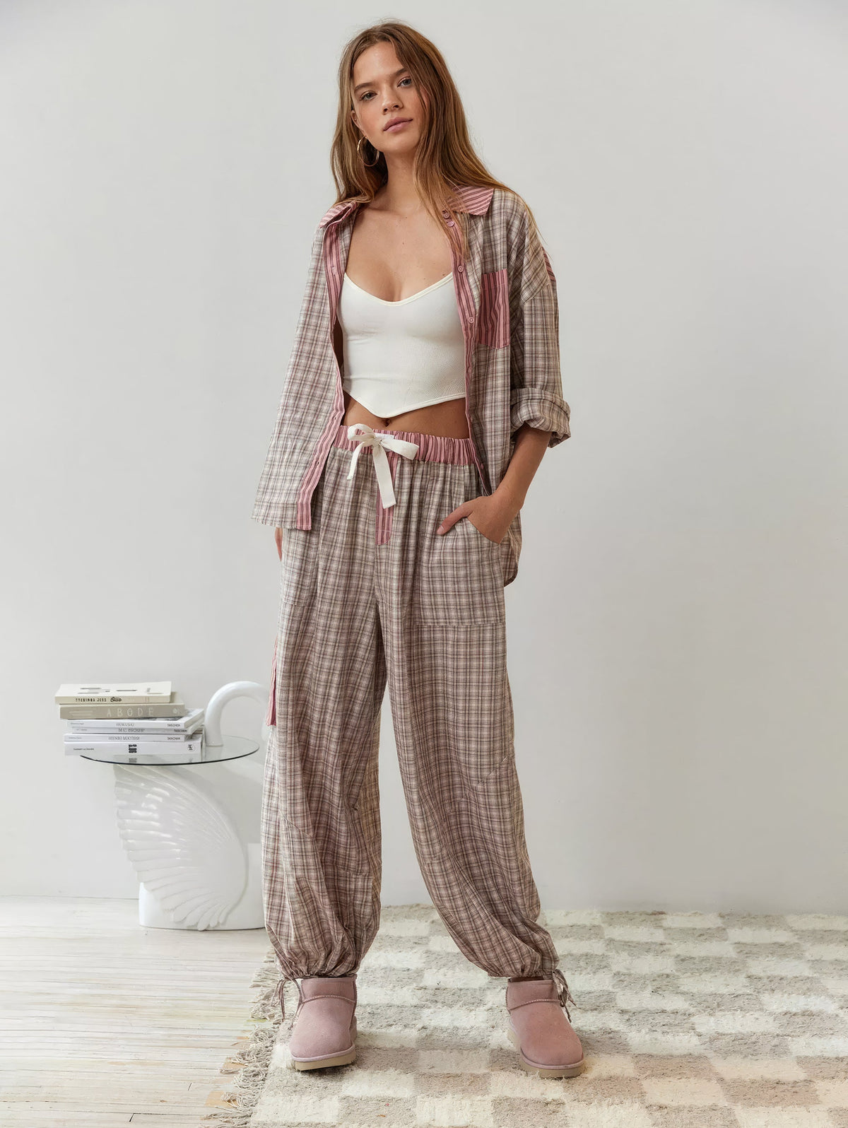 Full-length look in the pink check pyjama set, shirt worn open over a white top, with drawstring waist and gathered ankle ties. 6