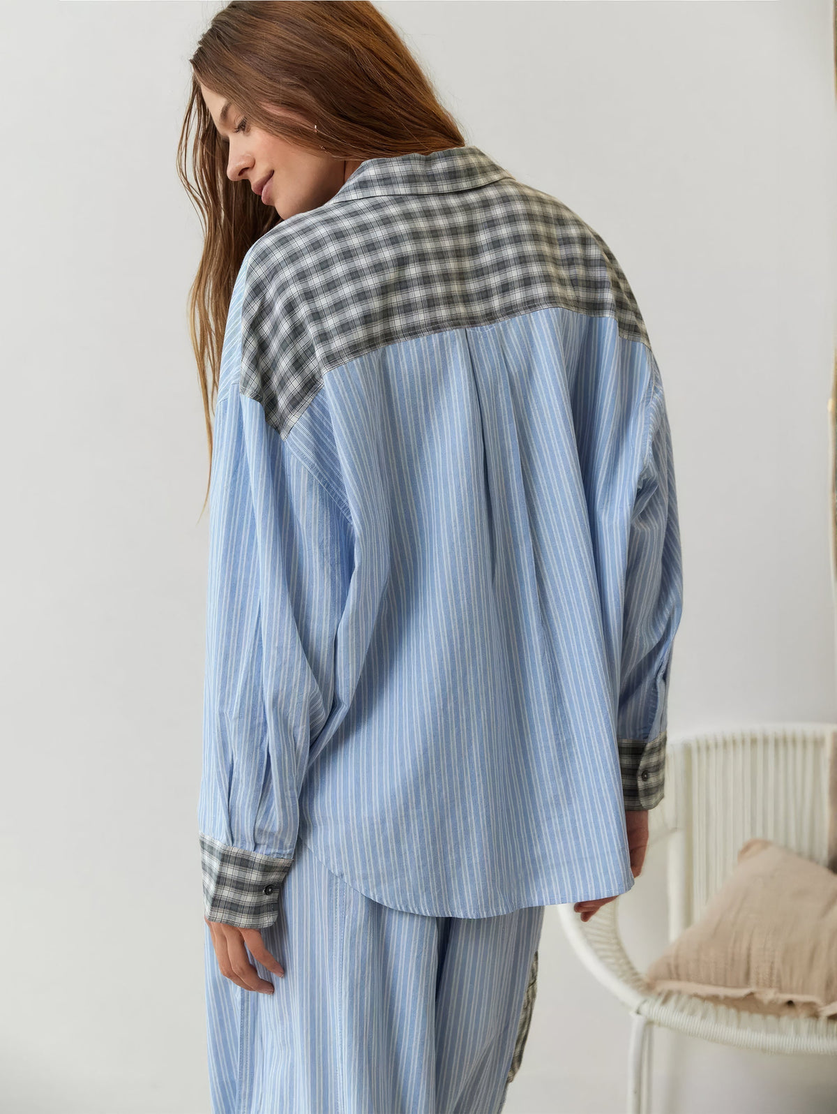 Back view of the blue-striped pyjama shirt, with a grey check yoke and collar and matching check cuffs. 9
