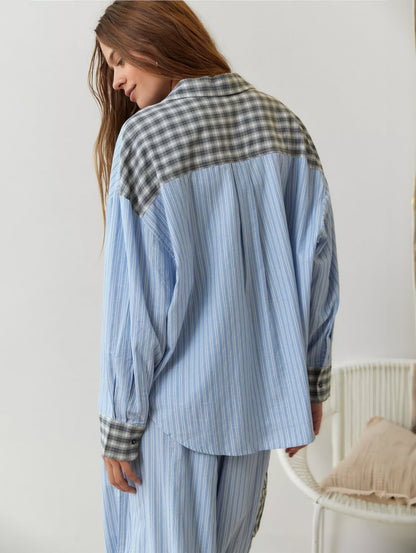 Back view of the blue-striped pyjama shirt, with a grey check yoke and collar and matching check cuffs. 9