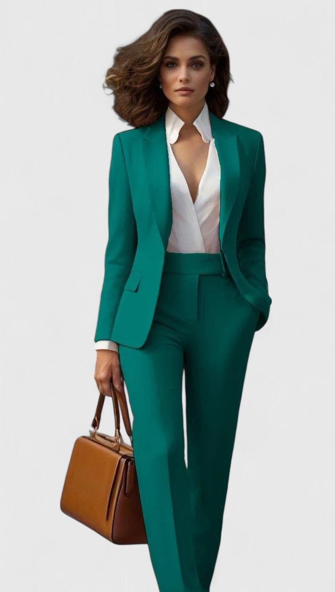 Model wearing the set in emerald green with a white wrap blouse and tan handbag 4