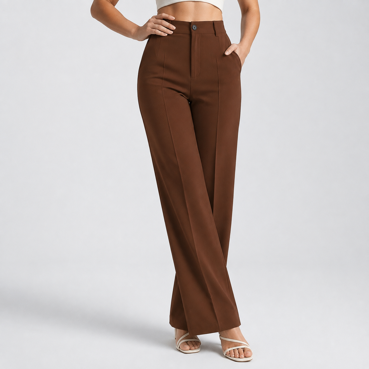 Chocolate brown trousers on a model with one hand on the hip and one in a pocket 14