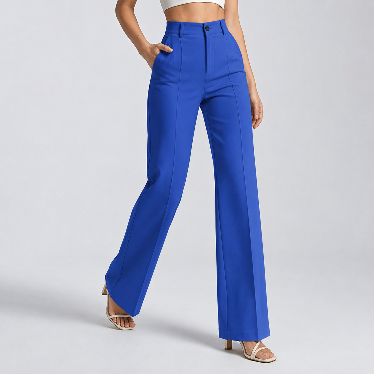 Bright royal blue trousers on a model mid-stride with one hand in the pocket 15