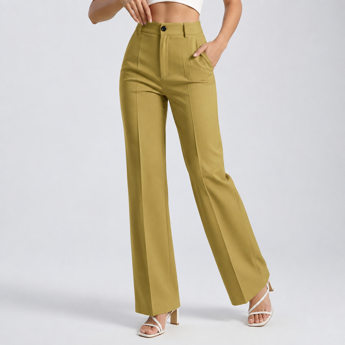 Model wearing mustard-yellow straight-leg trousers with front pleats and a hand in the pocket, with white heeled sandals 21