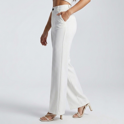 Side view of white trousers on a model walking, one hand in the side pocket 4