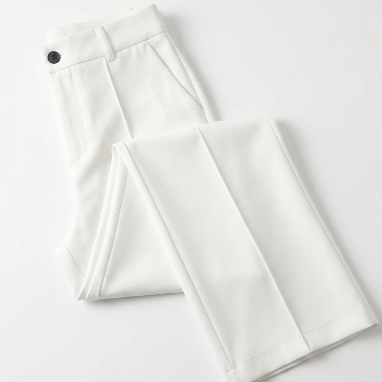White trousers folded flat on a plain white surface, showing the button waistband and pocket 7