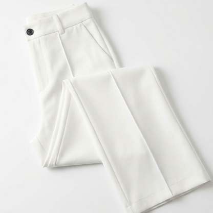 White trousers folded flat on a plain white surface, showing the button waistband and pocket 7