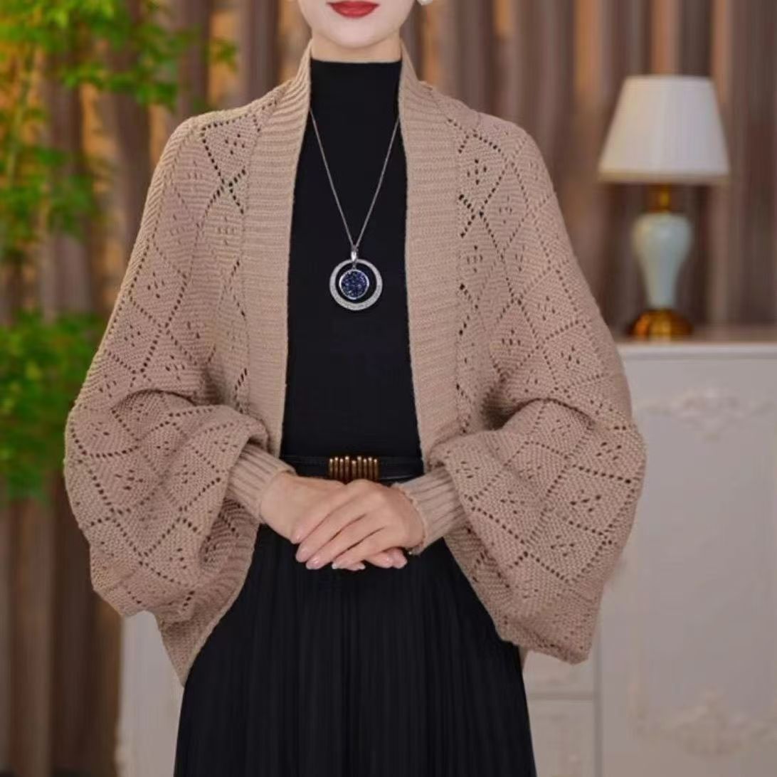 Model wearing the open knit shawl cardigan in light khaki, with wide batwing sleeves and ribbed cuffs 5