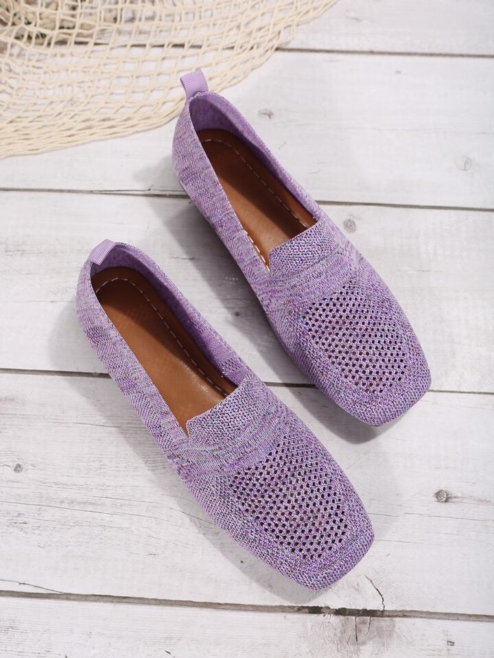 Pair of lilac mesh slip-ons on white painted boards, showing the brown stitched footbed and heel pull tabs. 13