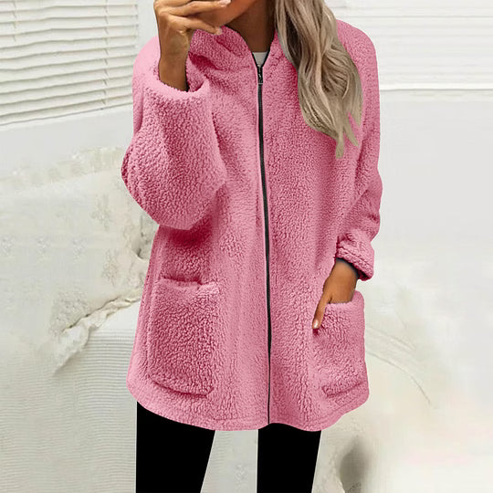Model wearing the zipped fluffy fleece jacket in pink with black leggings, hand in a pocket 5