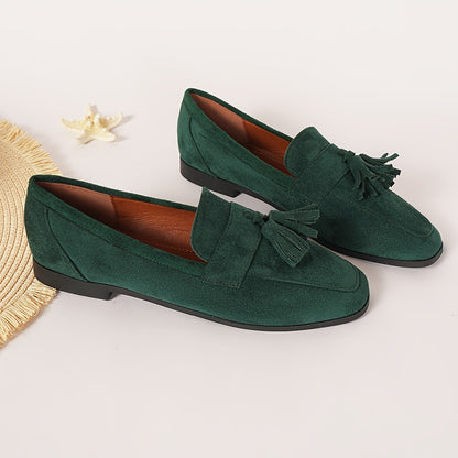 Pair of green tasselled loafers with tan lining beside a starfish and straw mat 12