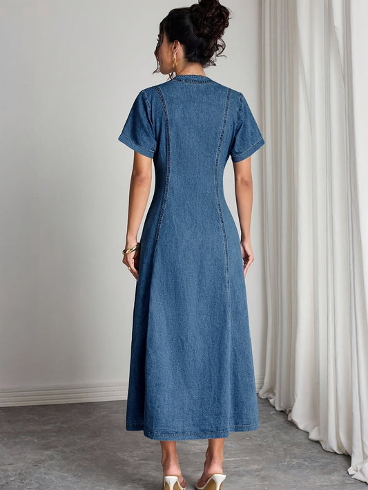 Back view of the short-sleeved denim dress on a model with her hair in a bun 2