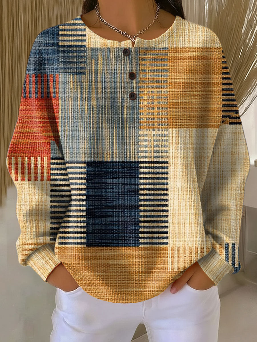 Waffle knit henley jumper with a patchwork print of navy, mustard, rust and cream stripes, worn by a model 3