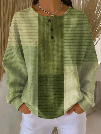Waffle knit henley jumper in blocks of light and dark green, three buttons at the neckline 4