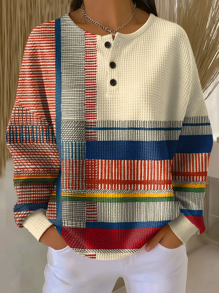 Cream waffle knit henley jumper with red, blue, yellow and green striped panels on the front and sleeves 6