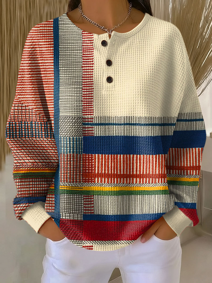 Cream waffle knit henley jumper with red, blue, yellow and green striped panels on the front and sleeves 6