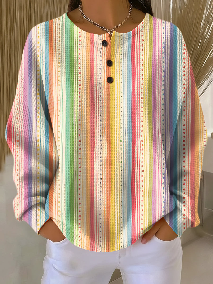 Waffle knit henley jumper with vertical rainbow stripes and small dotted lines in pastel shades 10