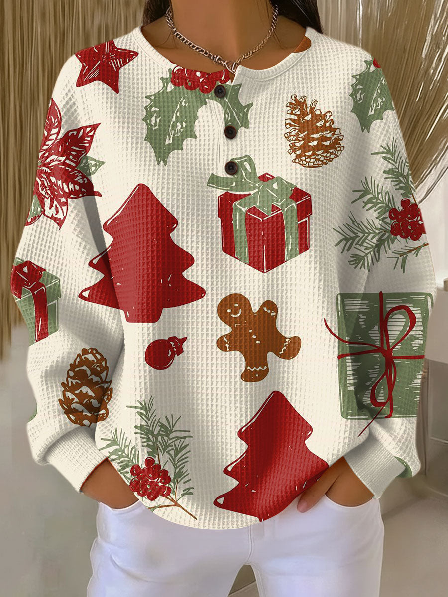 Cream waffle-knit button-neck jumper with red and green Christmas motifs: gingerbread man, presents, holly, pine cones and 23