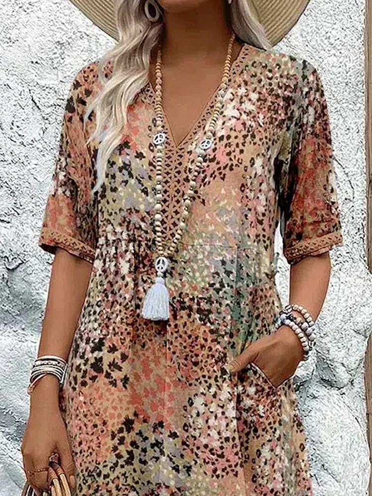 Close-up of the upper half in the earthy print, showing the V-neck with lace-style trim, short sleeves and gathered waist. 6