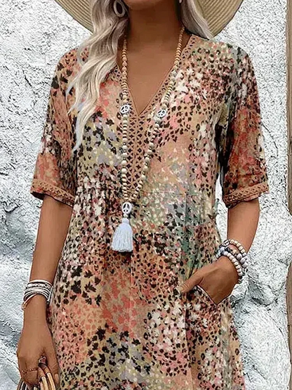 Close-up of the upper half in the earthy print, showing the V-neck with lace-style trim, short sleeves and gathered waist. 6