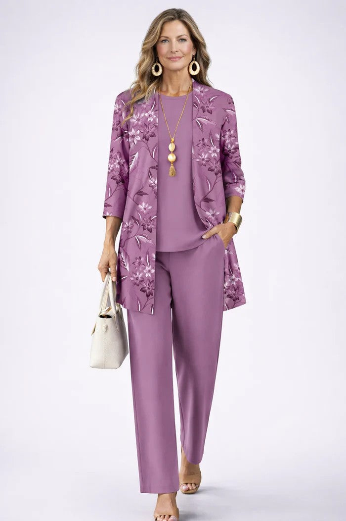 Model wears the purple set, the open cardigan printed with floral sprigs, one hand in pocket 11