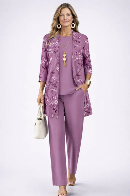 Model wears the purple set, the open cardigan printed with floral sprigs, one hand in pocket 11