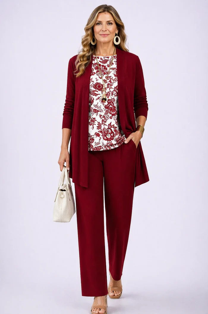 Model wears a plain red cardigan and trousers with a red and white floral printed top 13